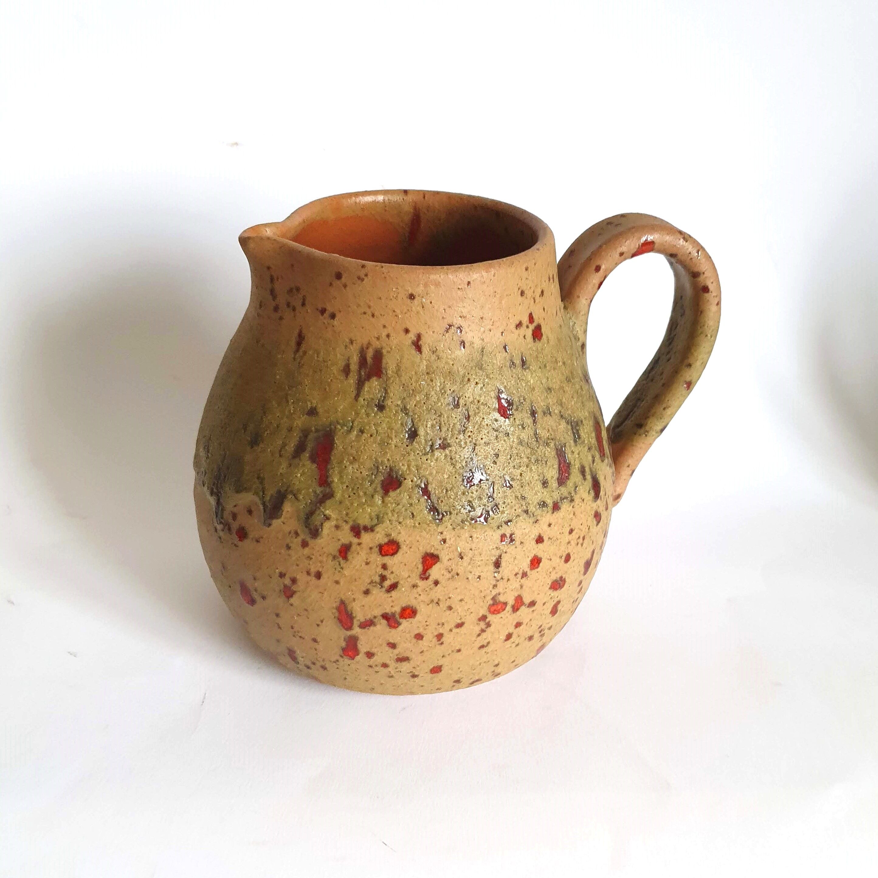 Red speckled stoneware pitcher by Campo Piano Orezza