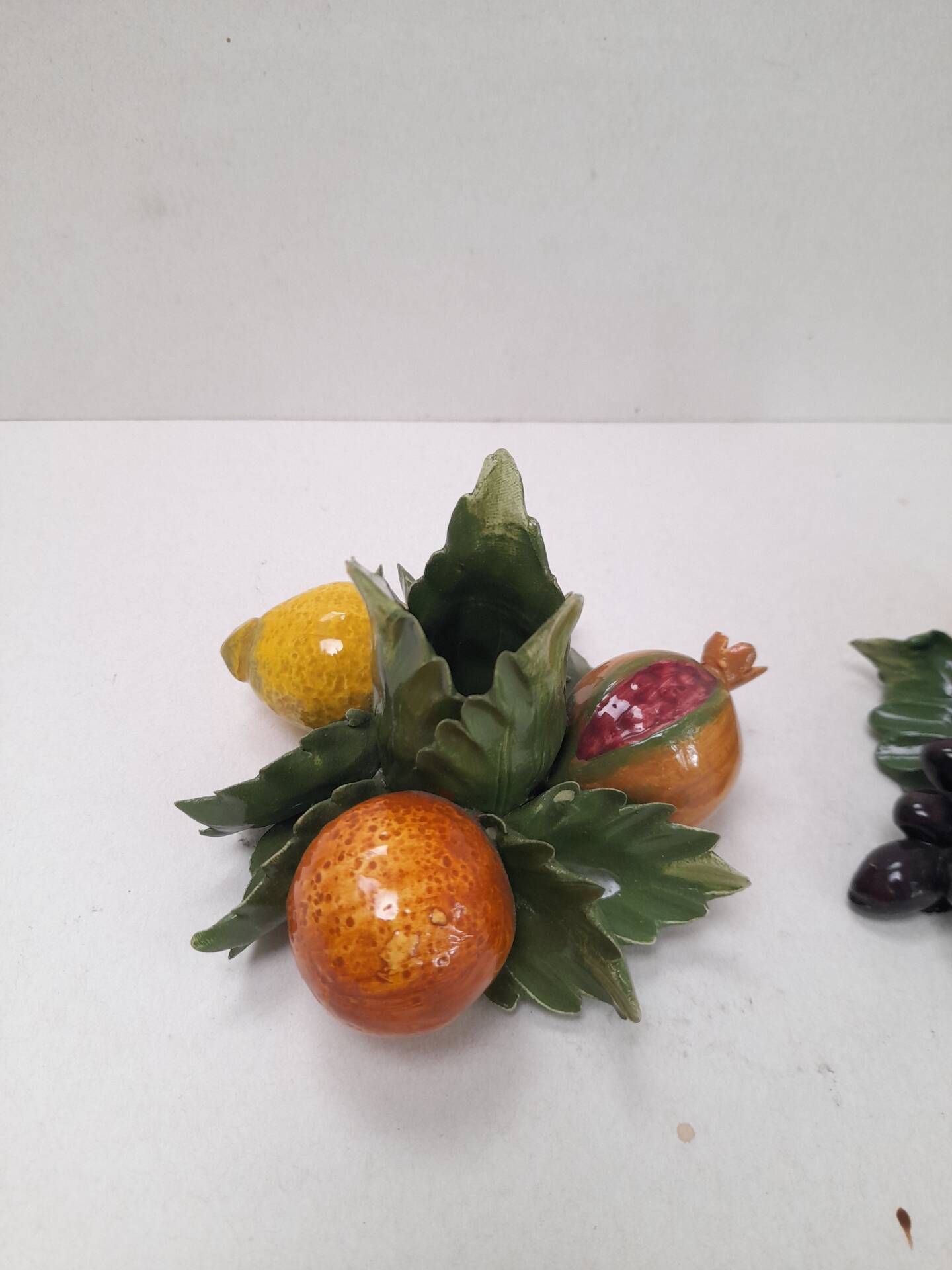 Pair of fruit candle holders in Italian majolica.