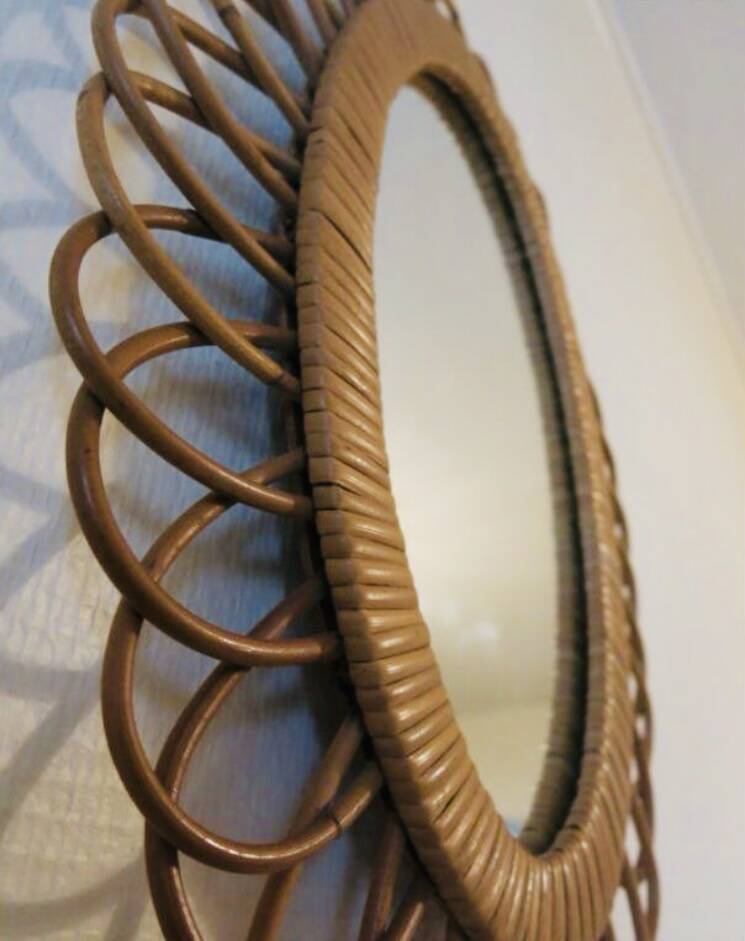 Vintage oval rattan mirror from the 60s and 70s with a rosette