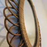 Vintage oval rattan mirror from the 60s and 70s with a rosette
