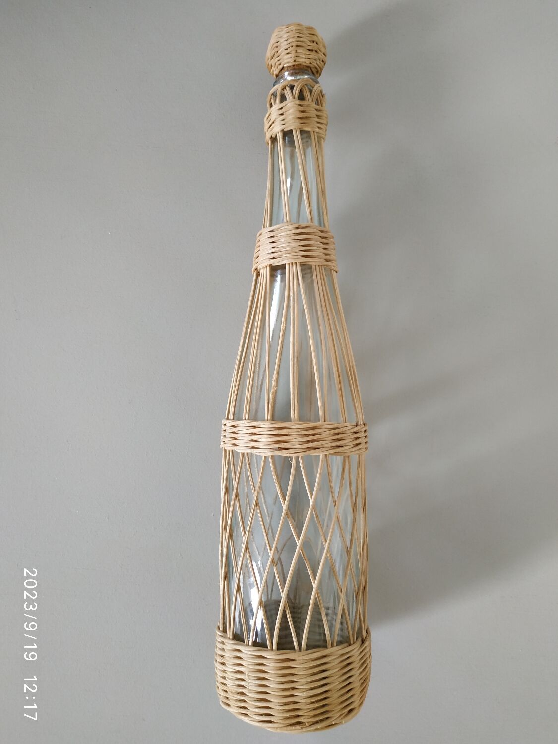 Glass and rattan bottle