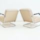 Pair of beige leather and tubular steel armchairs.