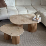 Oval coffee table duo travertine and raw fluted wooden legs.
