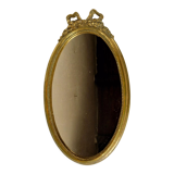 Golden oval mirror