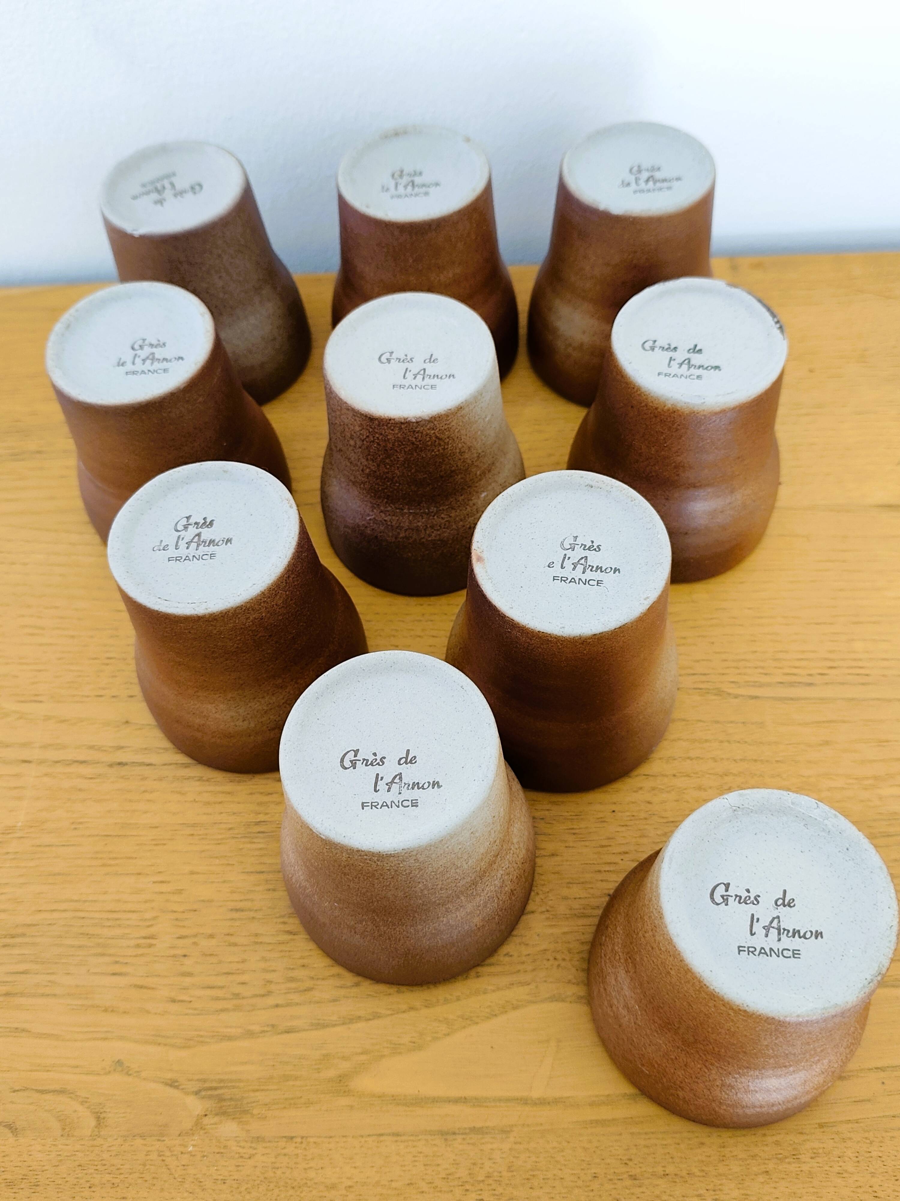 Stoneware cups – Armor stoneware set of 10 and an 11th French stoneware cup.