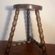 Round tripod stool with turned wooden legs