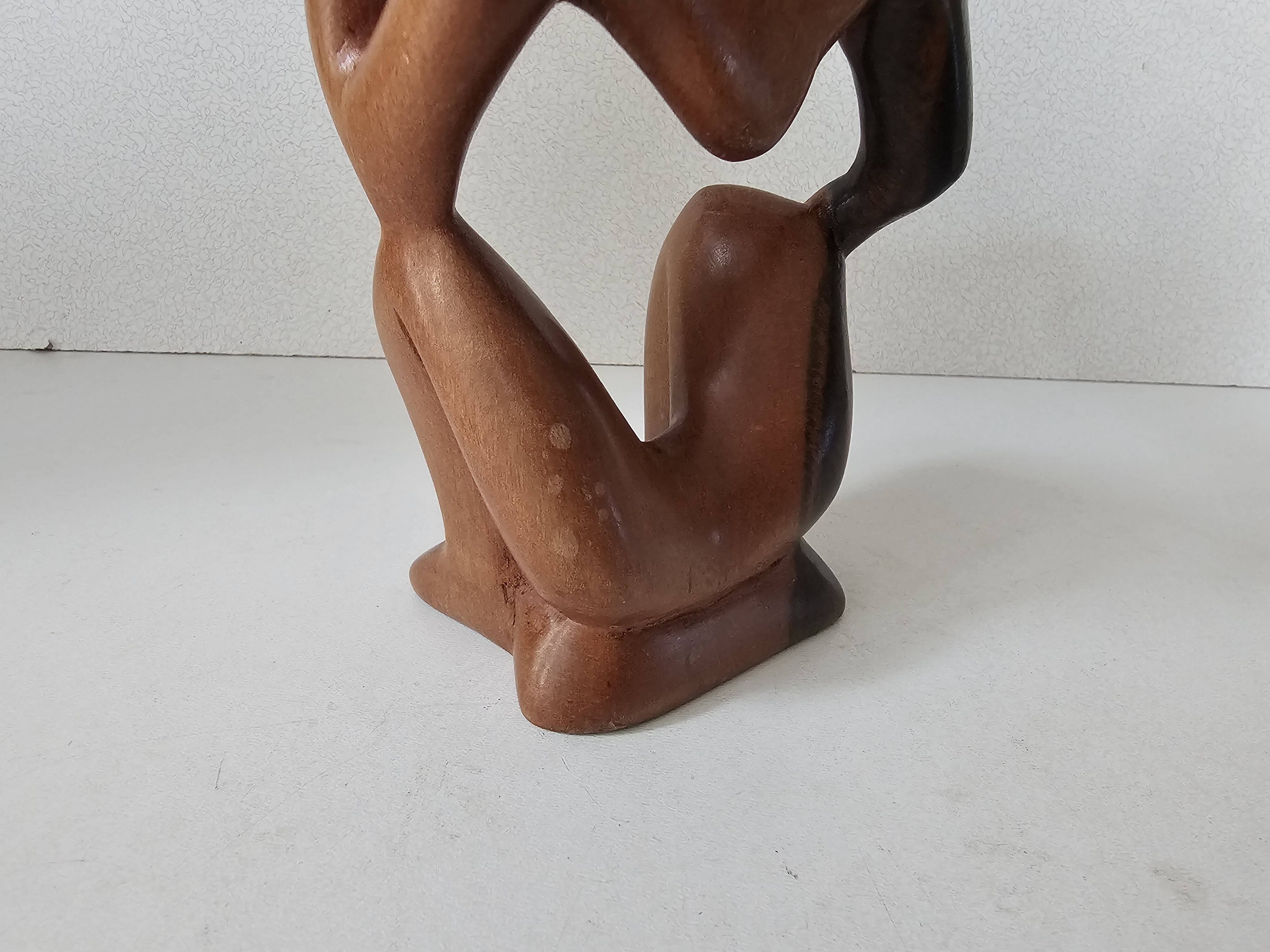Wooden statuette sculpture of a thinking man design