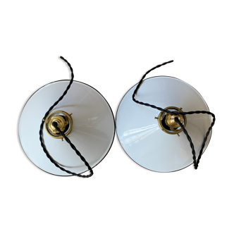 Old pair of white industrial metal suspensions with black border