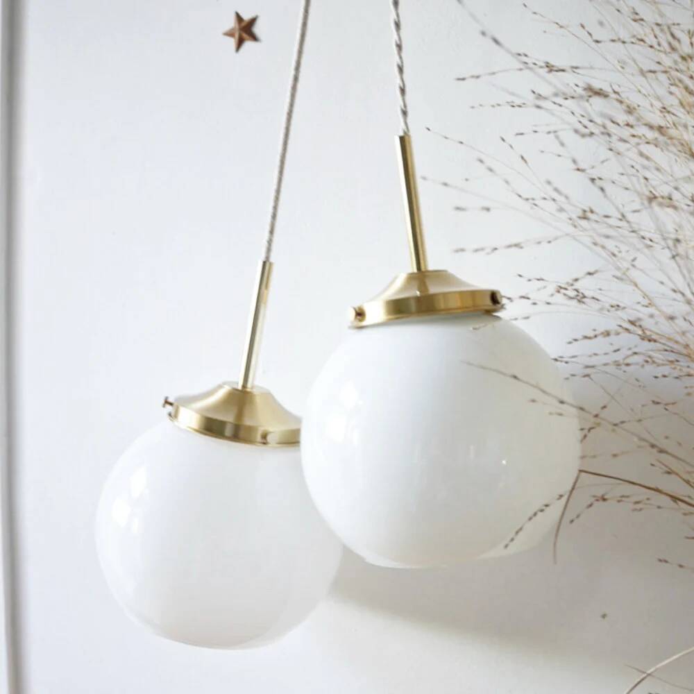 A pair of white opaline and brass suspensions.