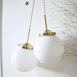 A pair of white opaline and brass suspensions.