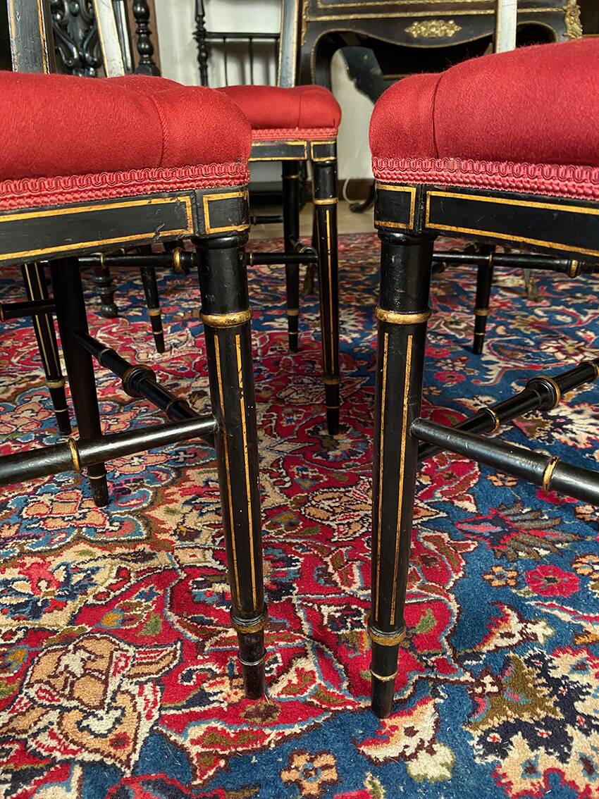 Set of four Napoleon III chairs in black lacquered wood with gold highlights.