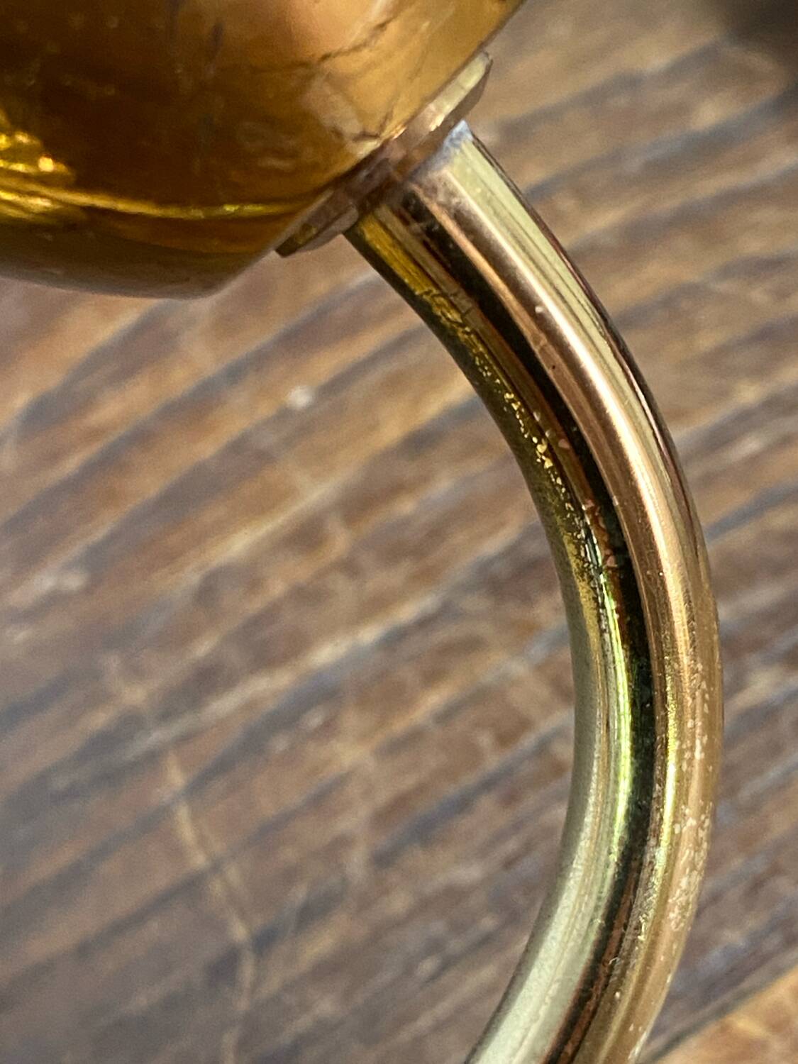 Gold metal wall light with ribbed glass.