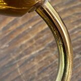 Gold metal wall light with ribbed glass.