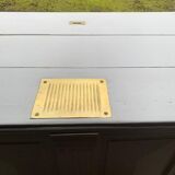 White counter with brass coin mechanism