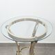 Neoclassical side table in brass and bevelled glass with ram's heads, 1970s.