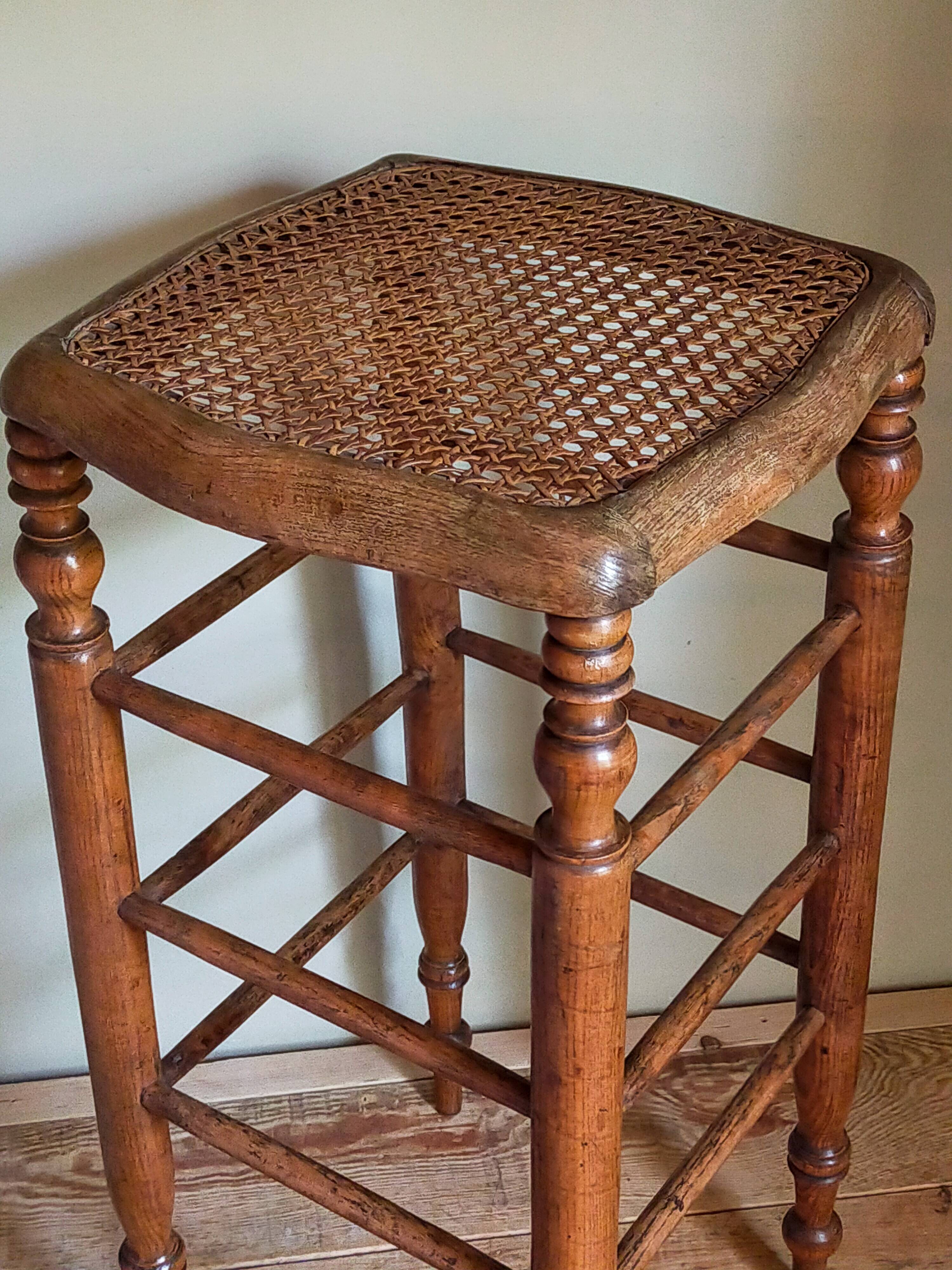 Antique stool with cane and turned wood