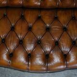 Pair of leather Chesterfield sofas by Howard & Sons