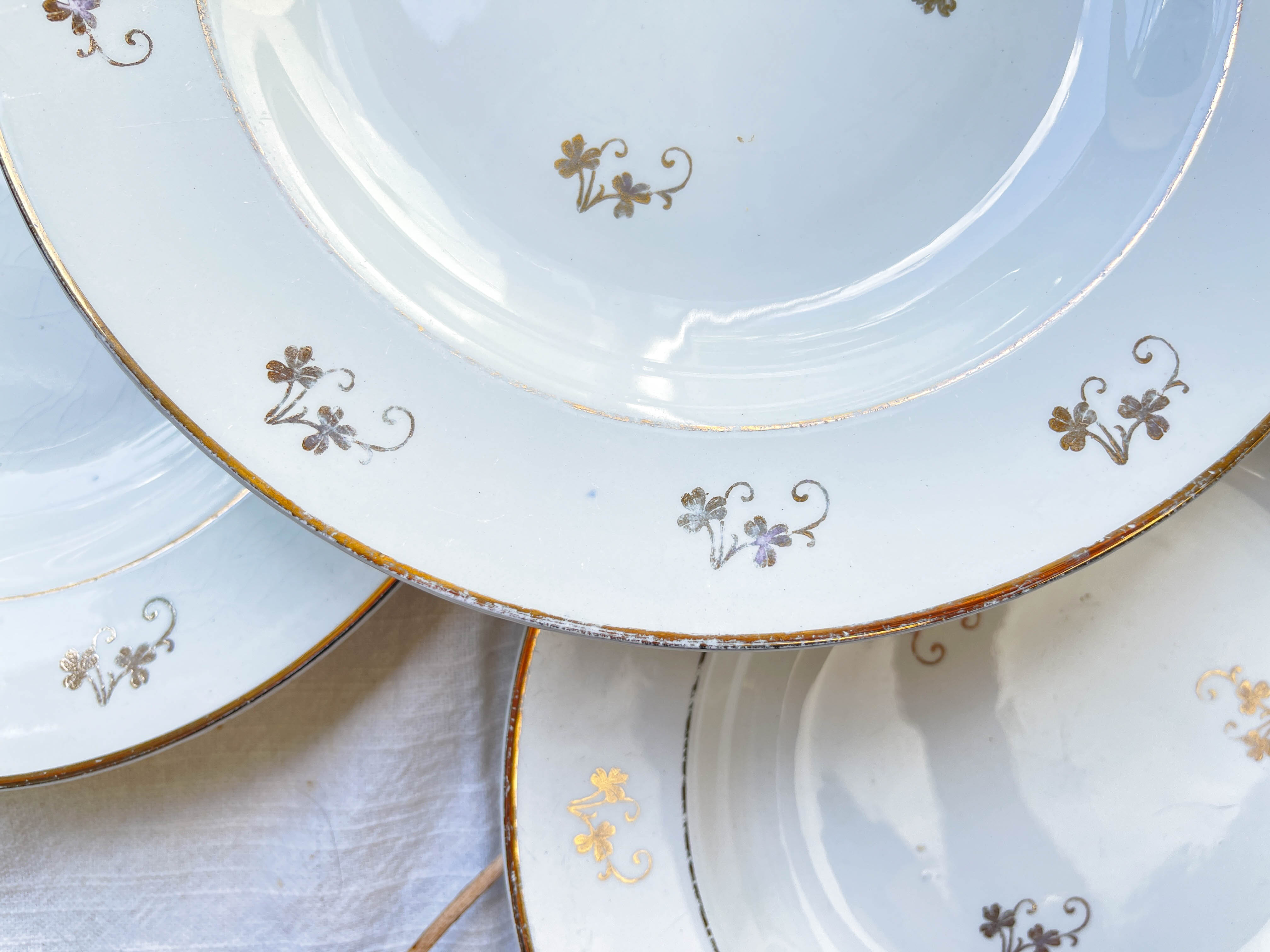 4 white porcelain L'Amandinoise soup plates with gold floral pattern