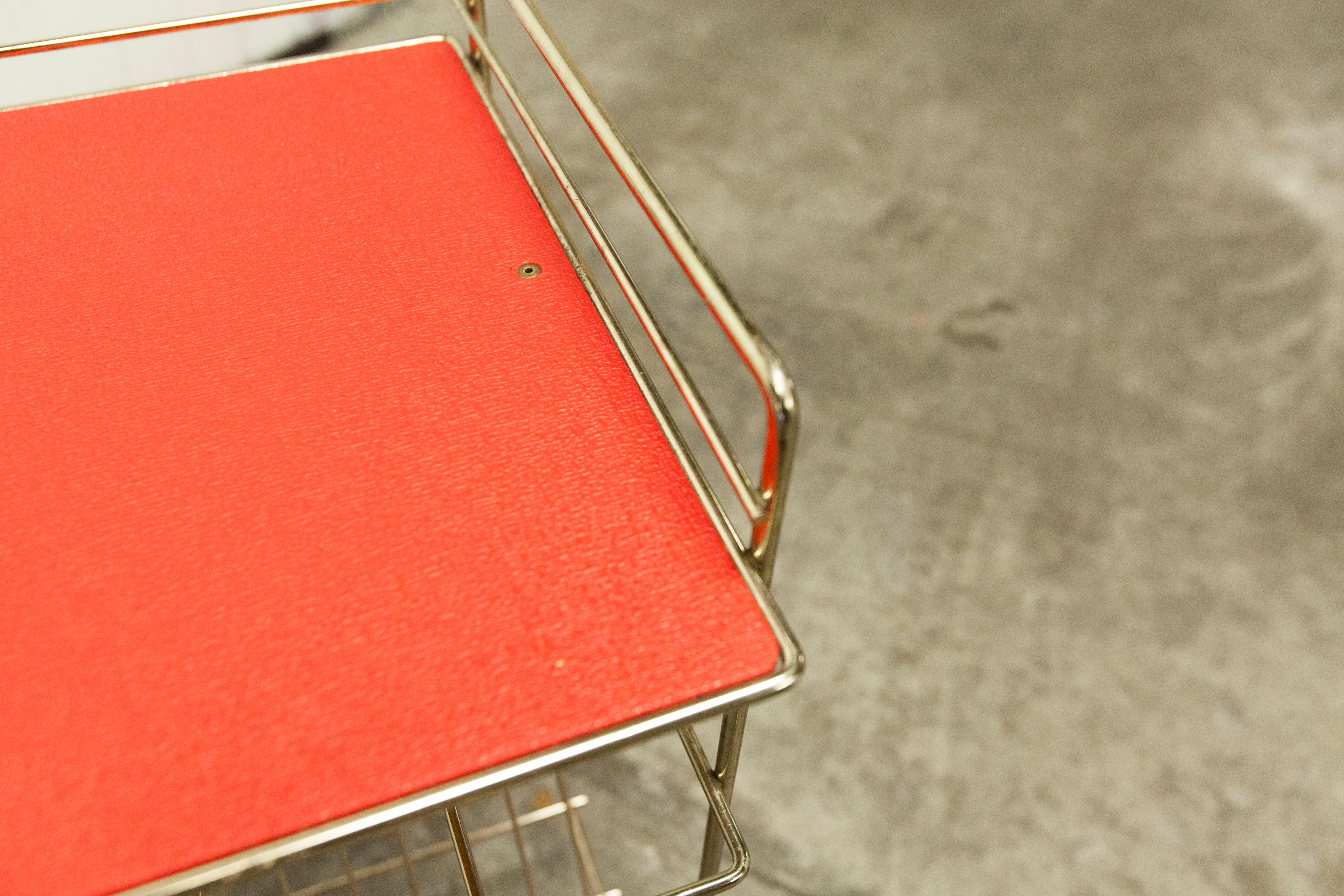 Red and brass vintage roulette service with vinyl record rack