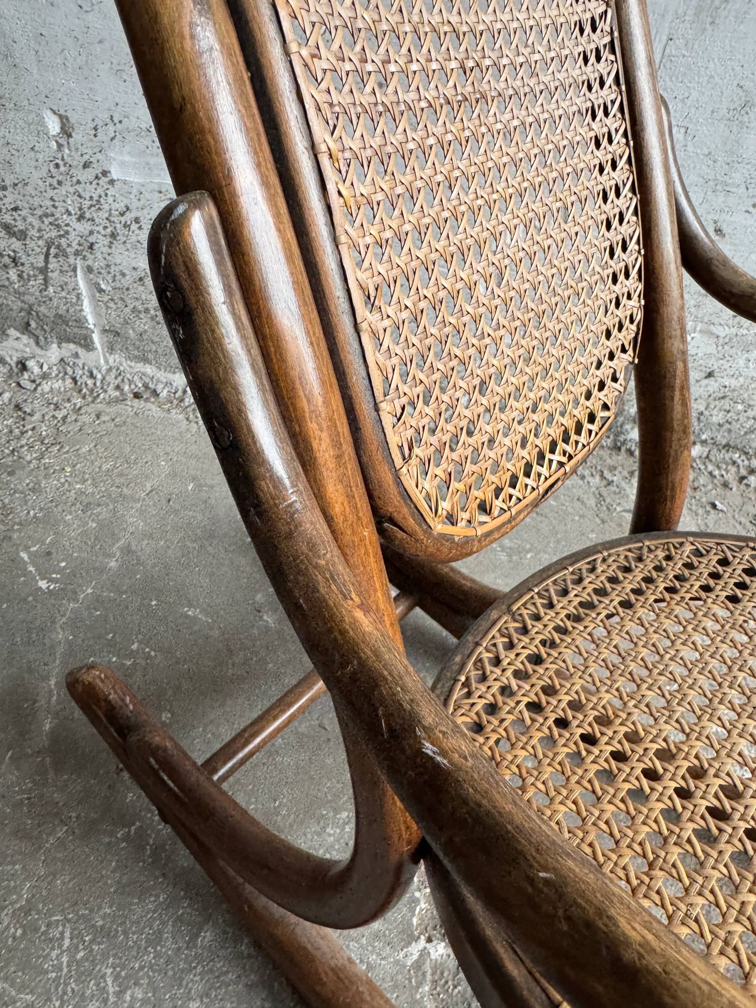 Warm walnut bentwood and cane child's rocking chair early 20th-century