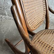 Warm walnut bentwood and cane child's rocking chair early 20th-century