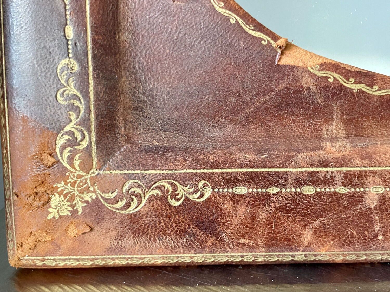 Antique leather framed mirror with gildings 30 cm x  24 cm