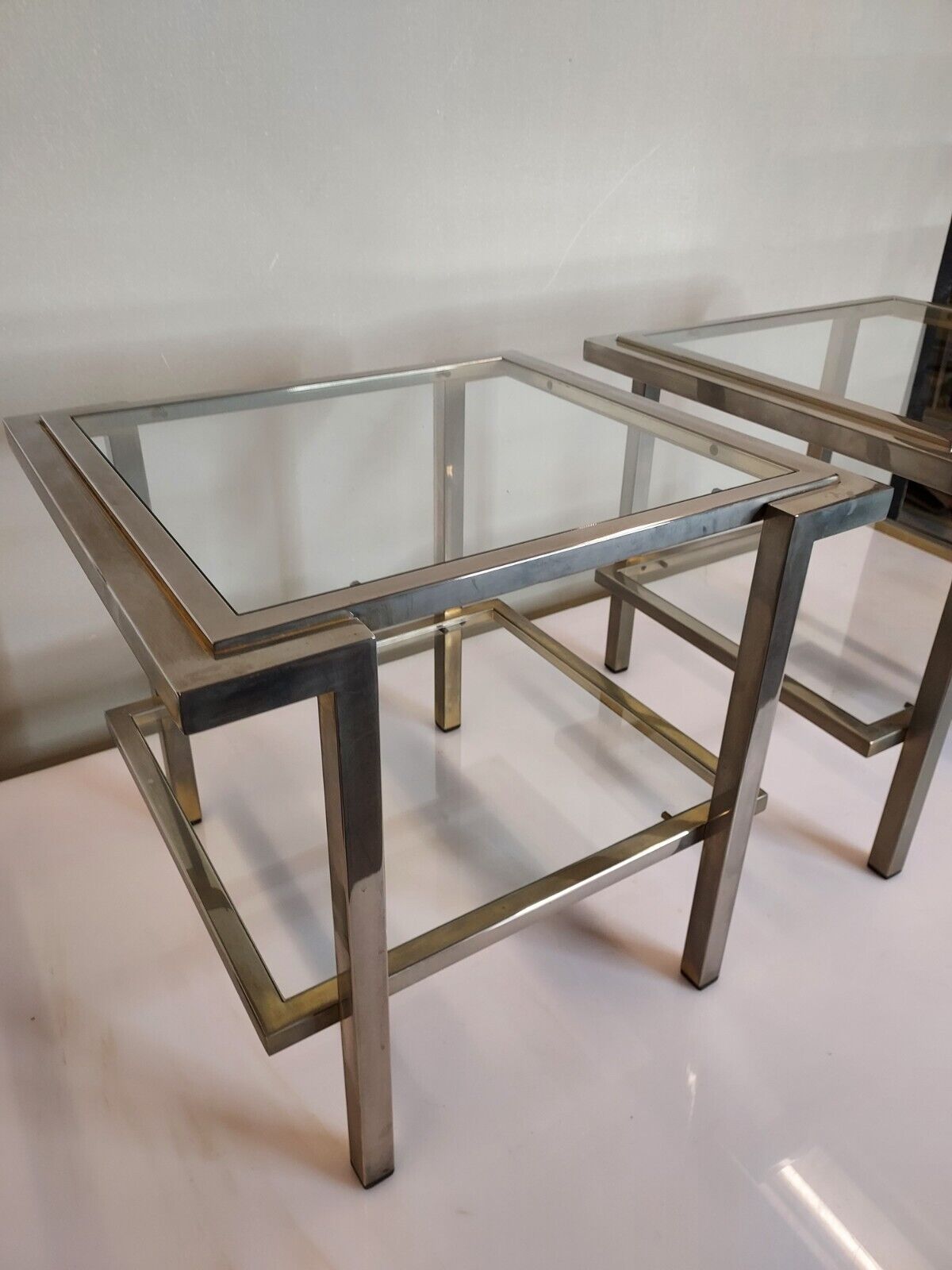 Pair of end of sofas in brushed iron signed Guy Lefevre