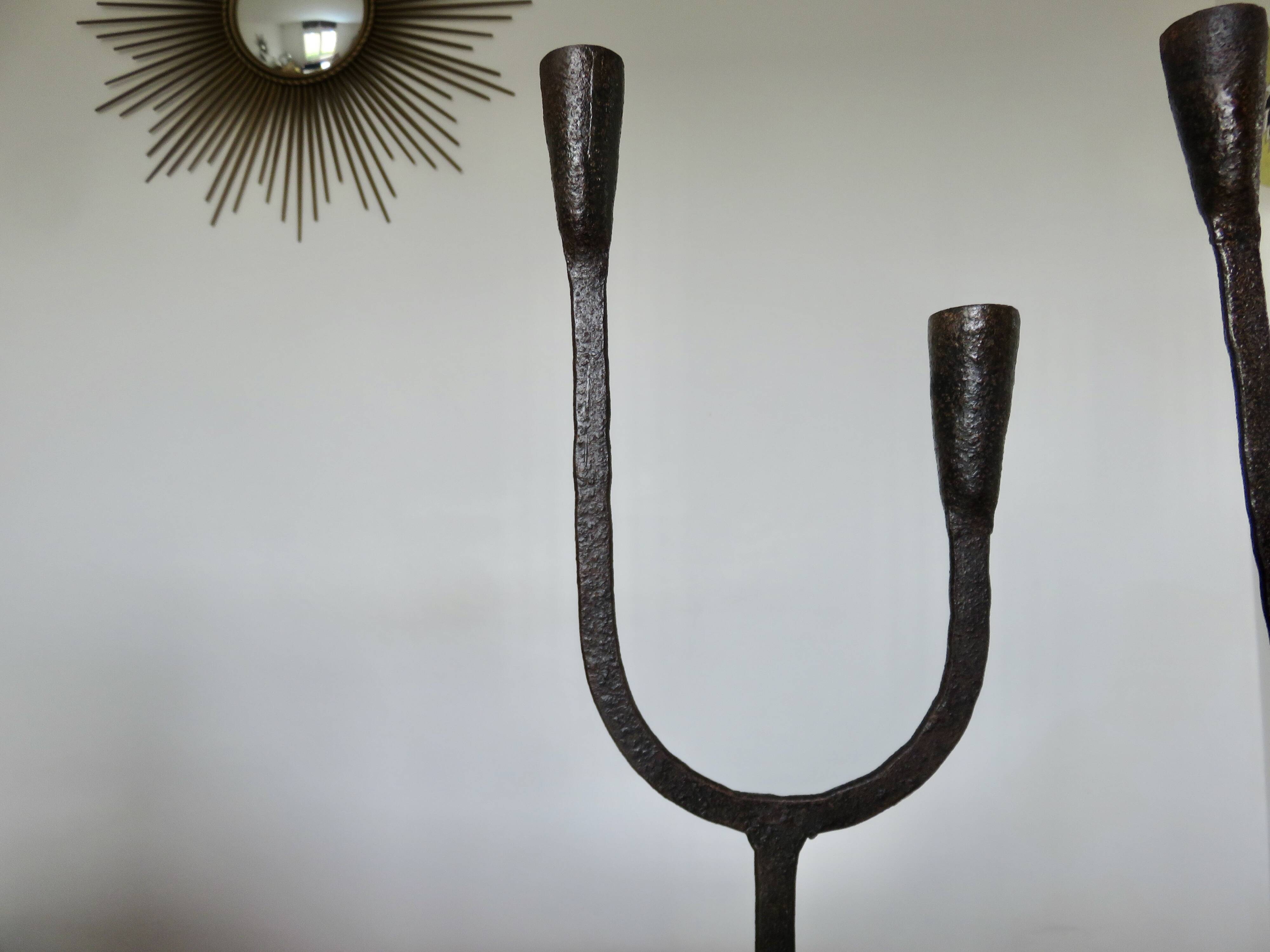 Pair of antique wrought iron candlesticks