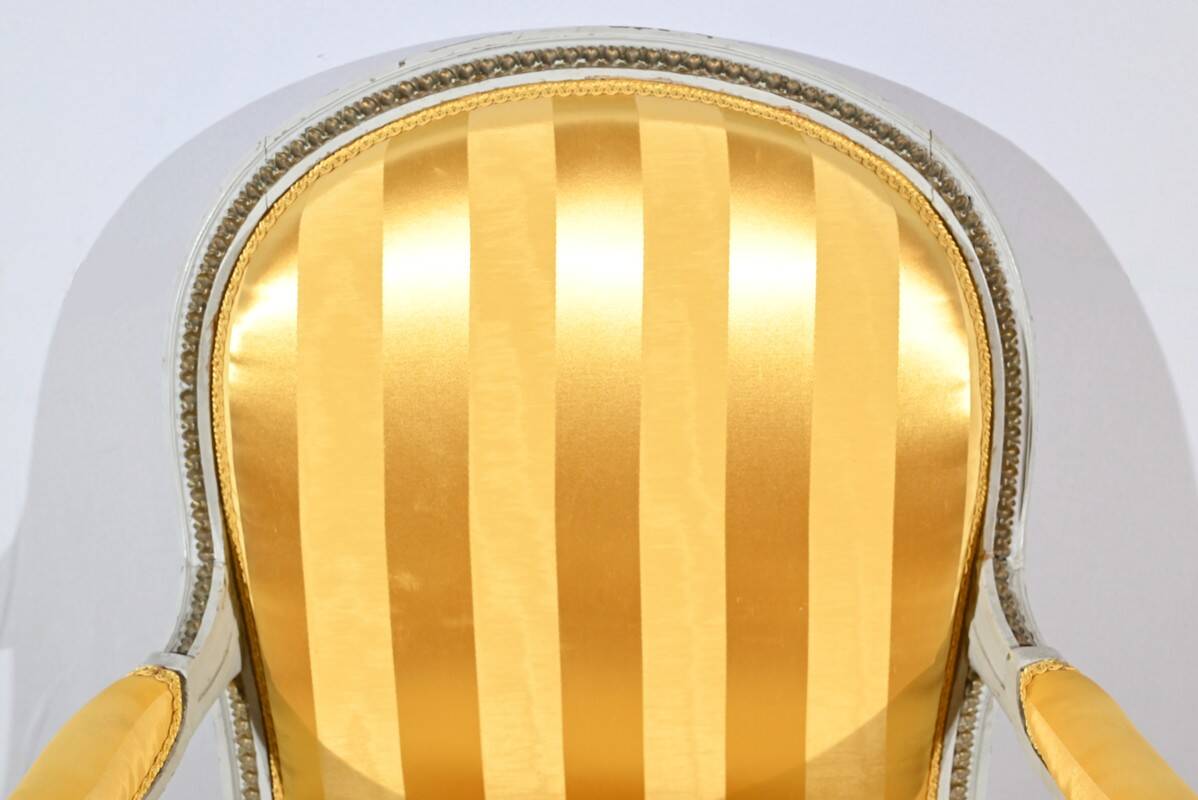 Pair of Cabriolet Armchairs, in rechampi wood, Louis XVI style – Late 19th century