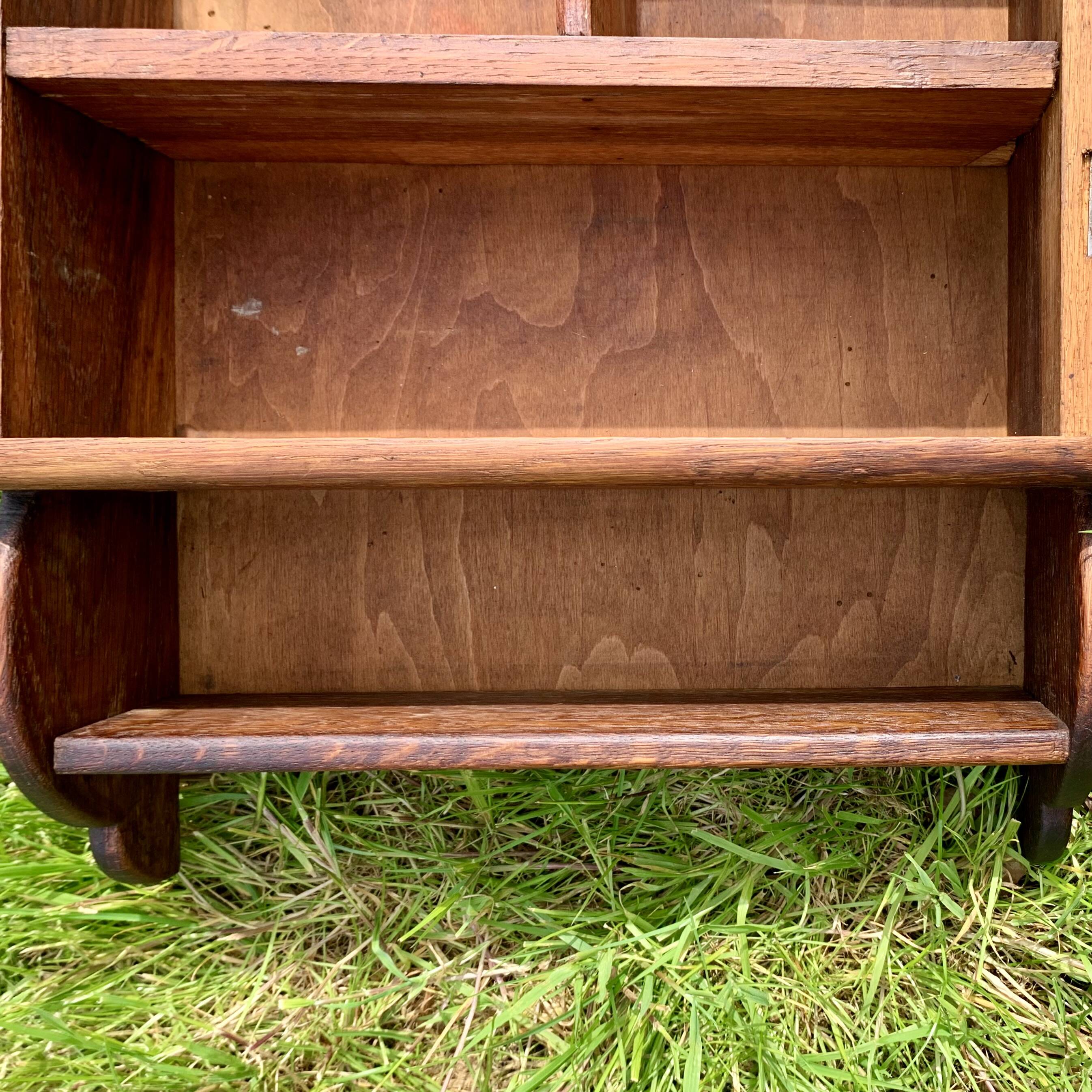 Old carved wooden medicine cabinet with beveled mirror