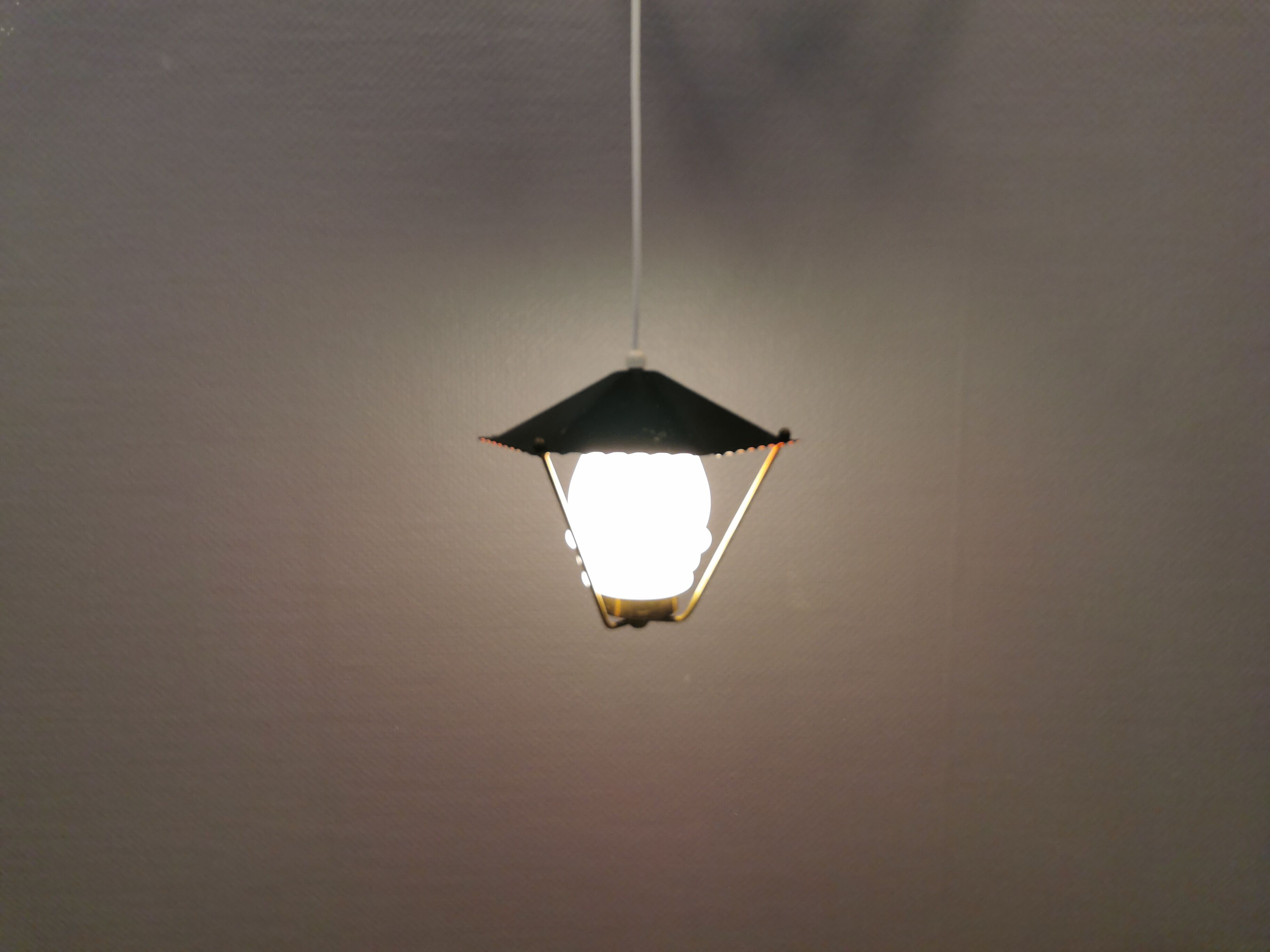Danish hanging lamp from the 50-60s, made of brass, metal and with milky white glass shade.