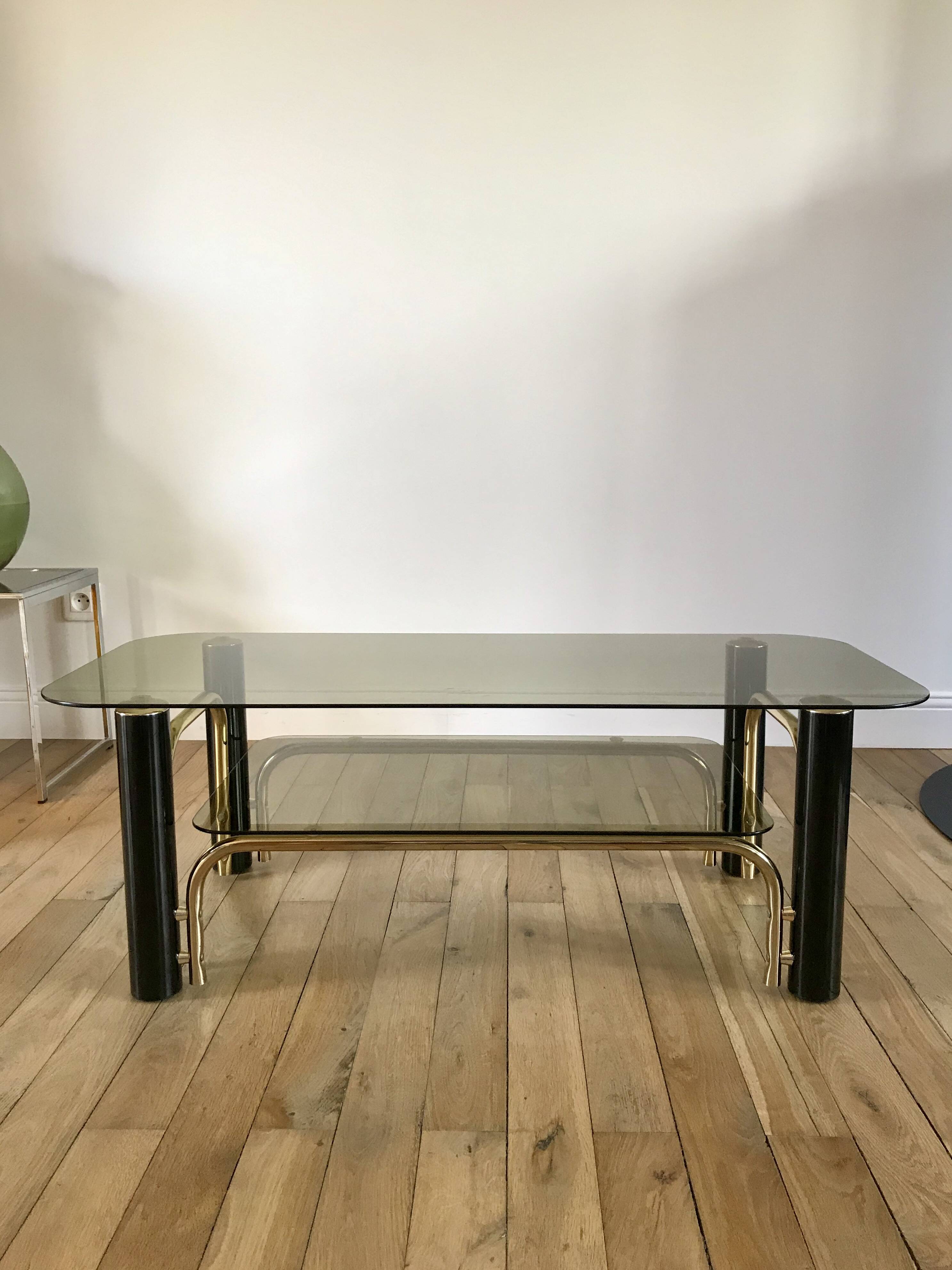 coffee table in smoked glass and black and gold metal from the 70s