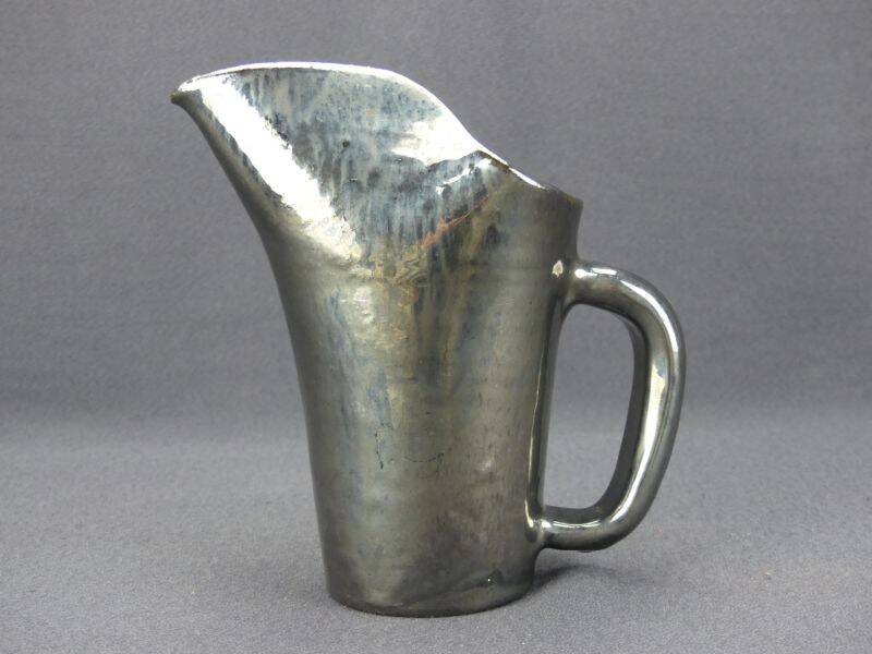 Old Biot, modernist pitcher in iridescent black ceramic.