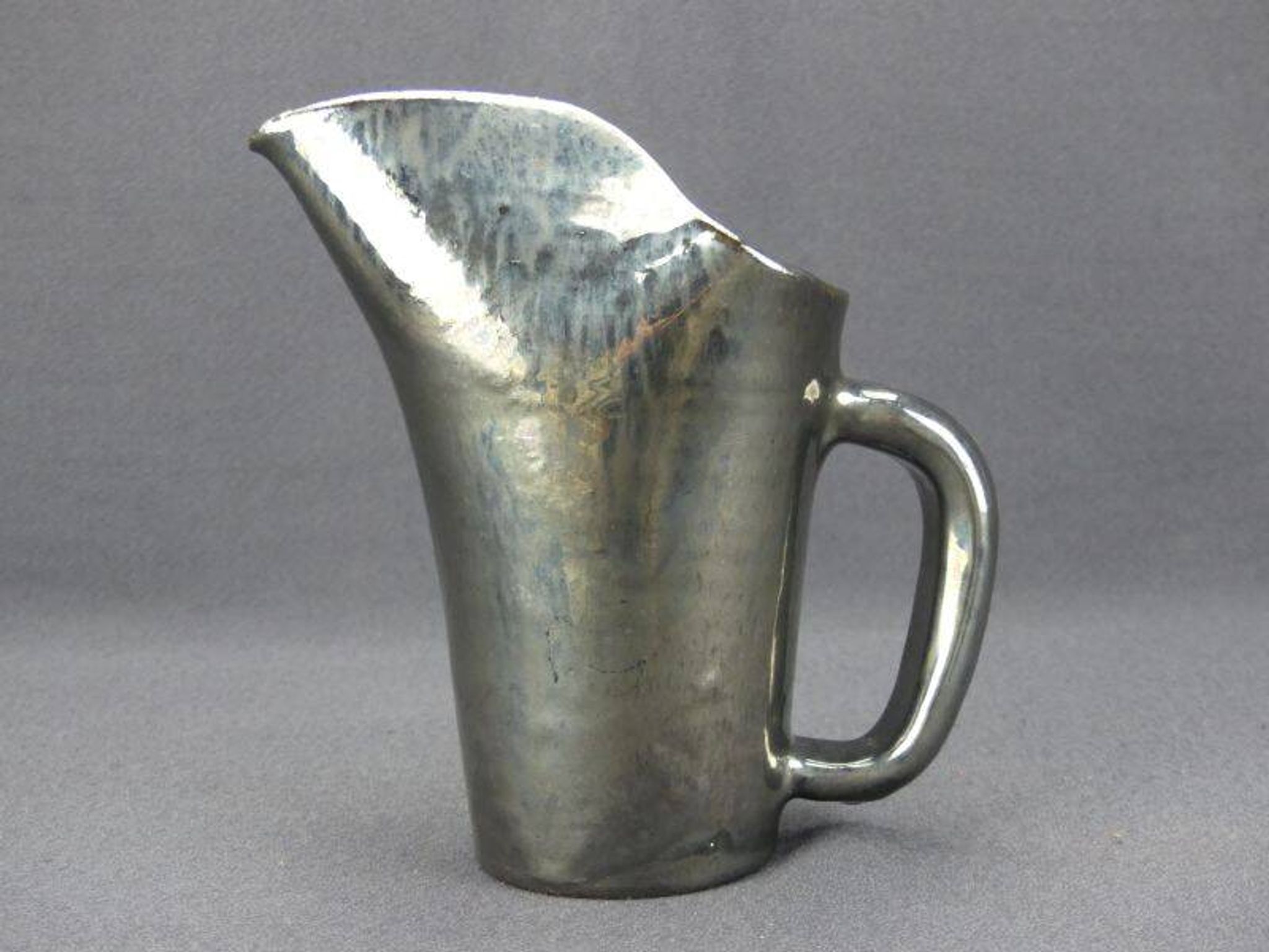 Old Biot, modernist pitcher in iridescent black ceramic.
