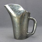 Old Biot, modernist pitcher in iridescent black ceramic.