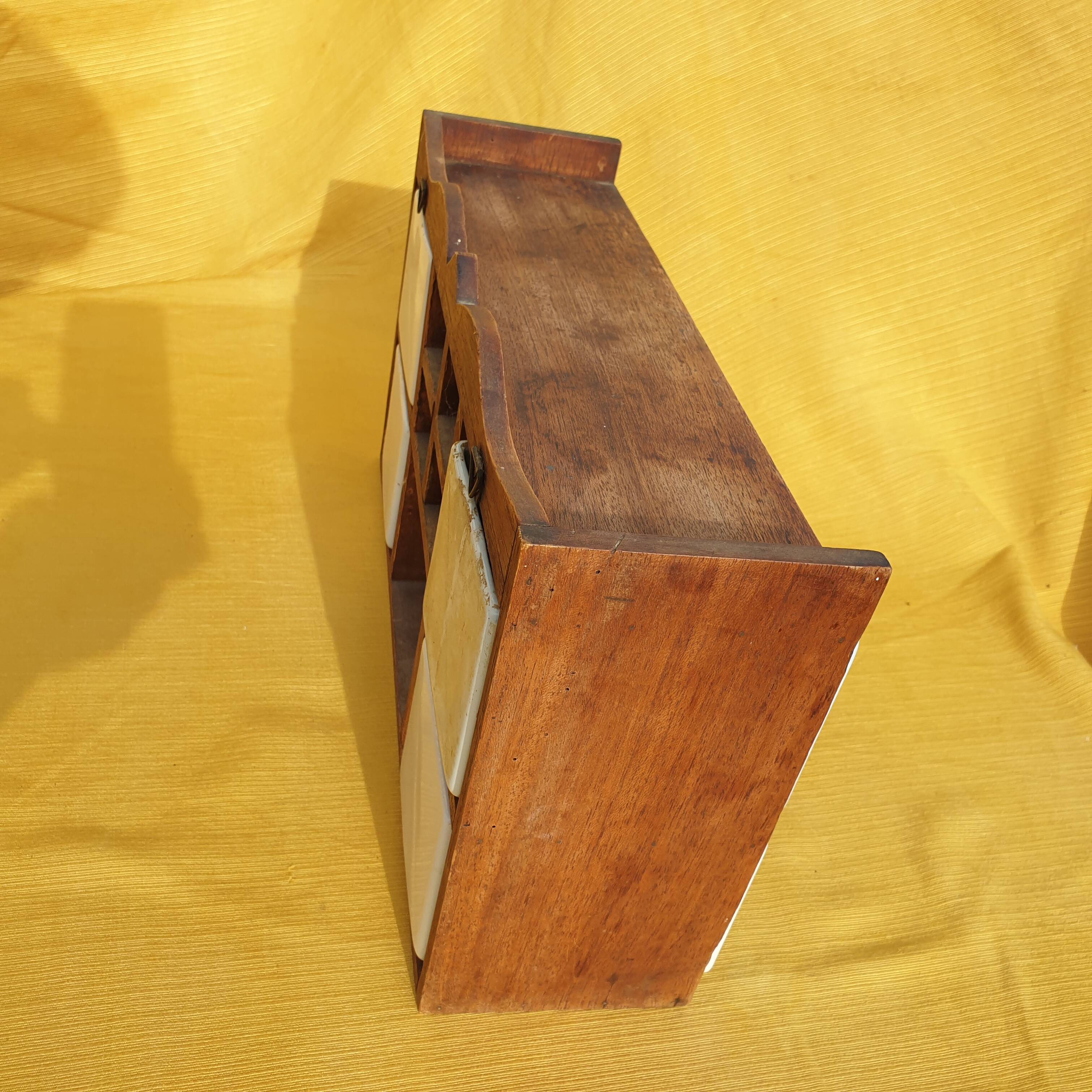 Vintage wooden spice rack with ceramic drawers