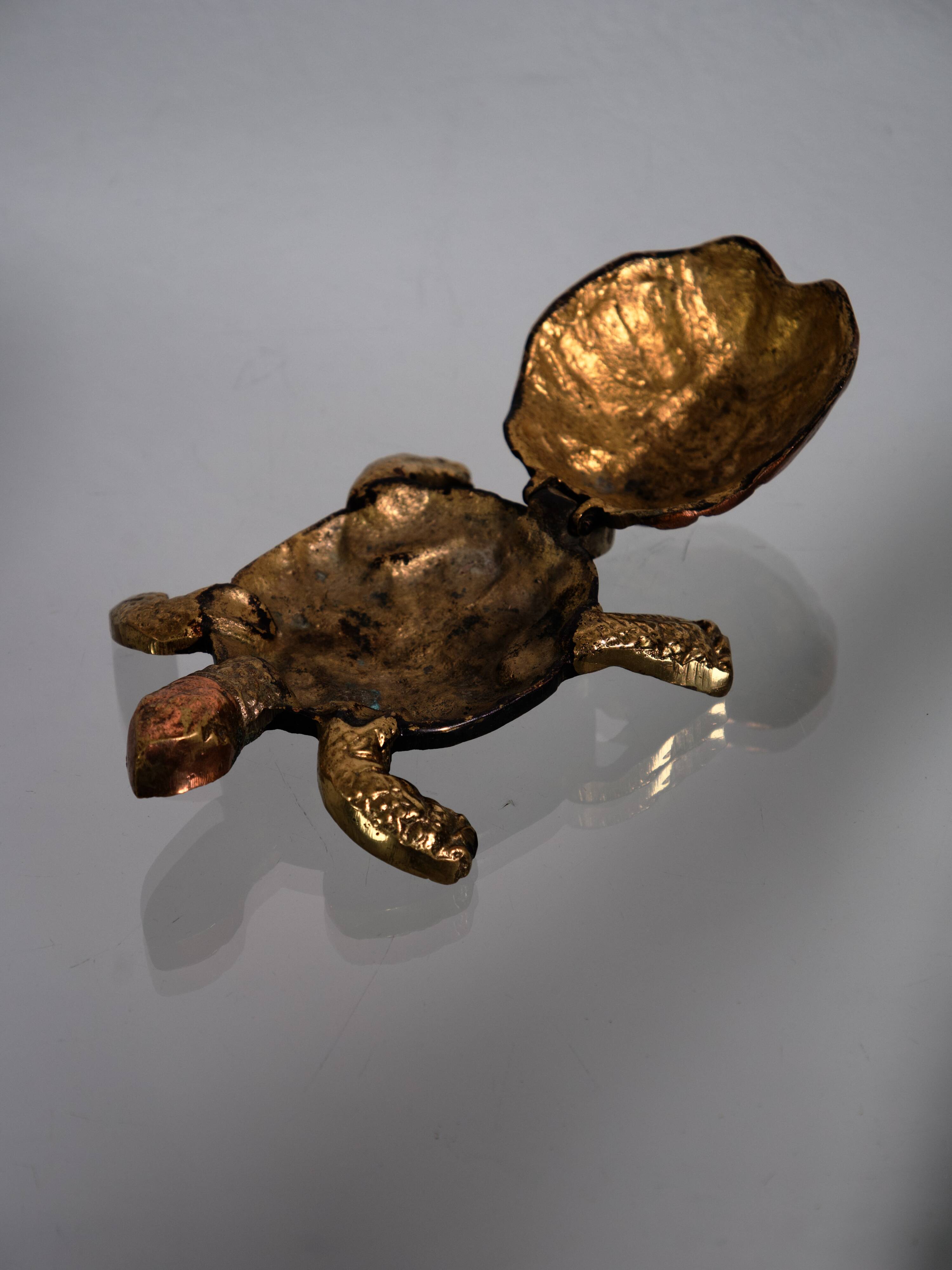 Golden brass turtle in decorative ashtray