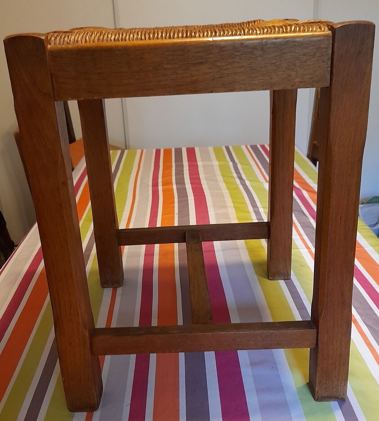 Oak stool seated in straw