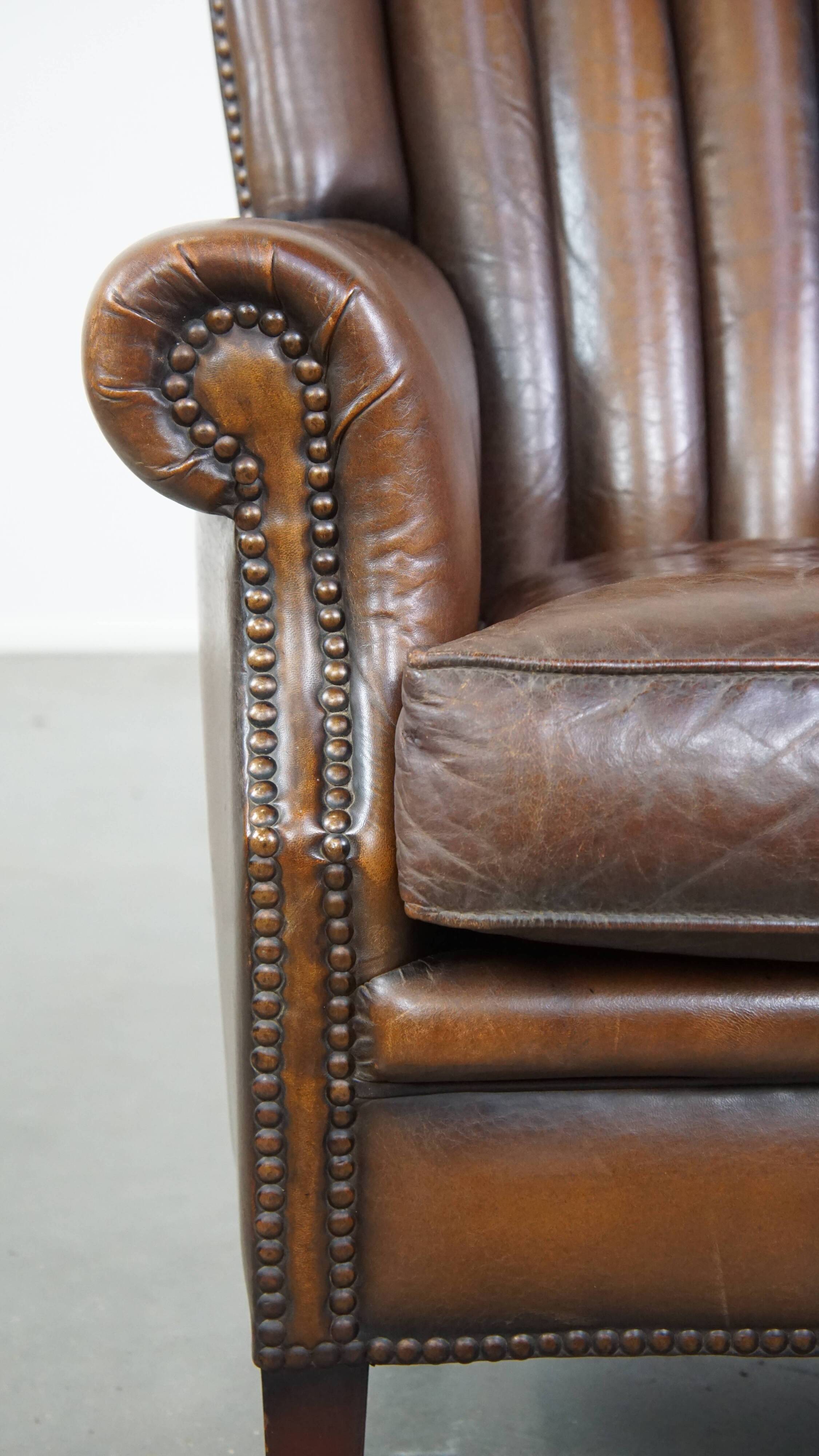 Sheep leather armchair finished with decorative nails