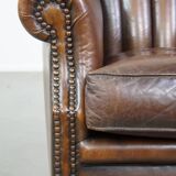 Sheep leather armchair finished with decorative nails