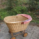 Doll cradle on wicker wheels