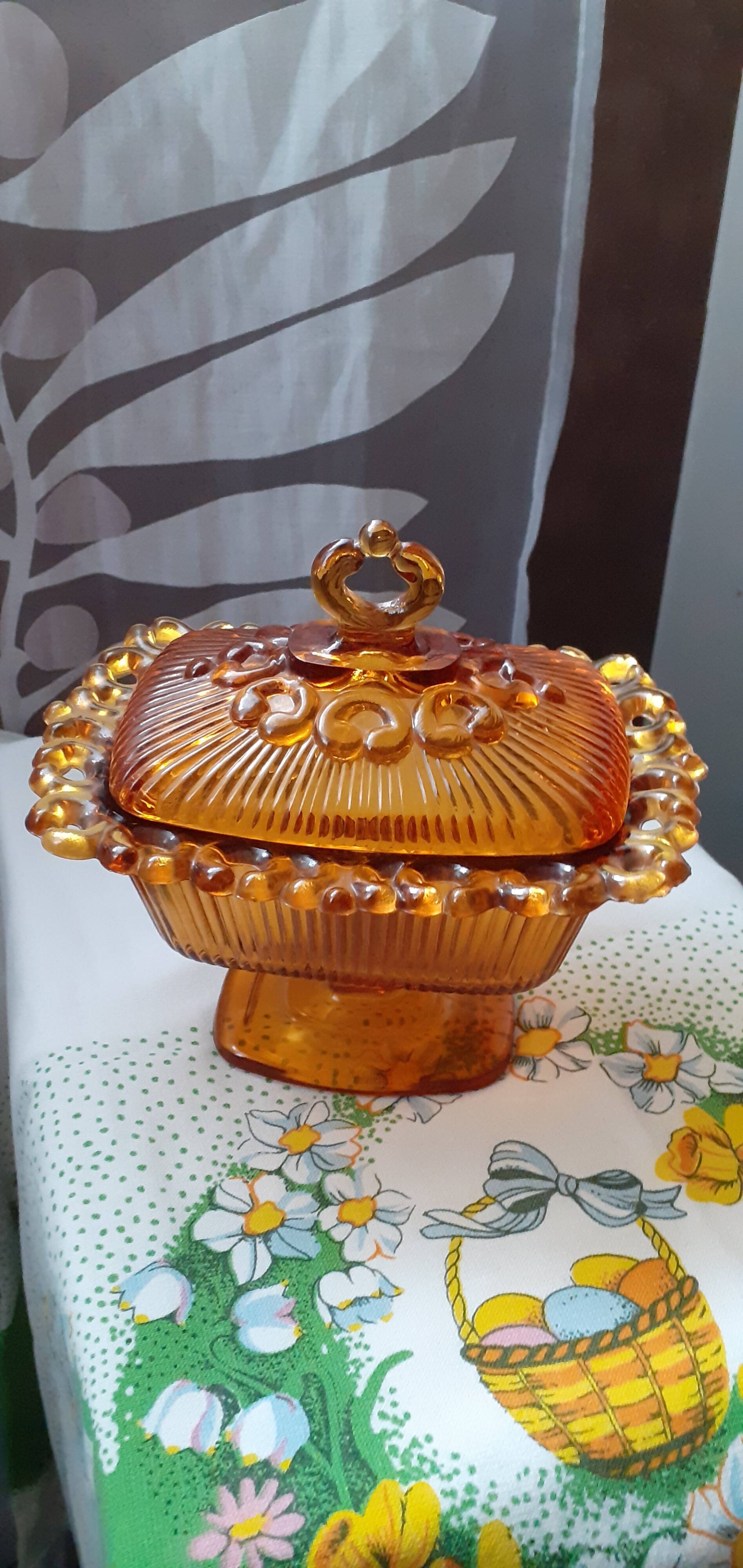 amber-colored pressed glass butter dish