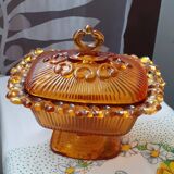 amber-colored pressed glass butter dish