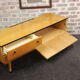 Black-gloved 50s varnished wooden sideboard