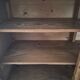 Antique wooden sideboard with three sliding glass doors.