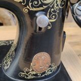 Old Singer sewing machine on pedestal