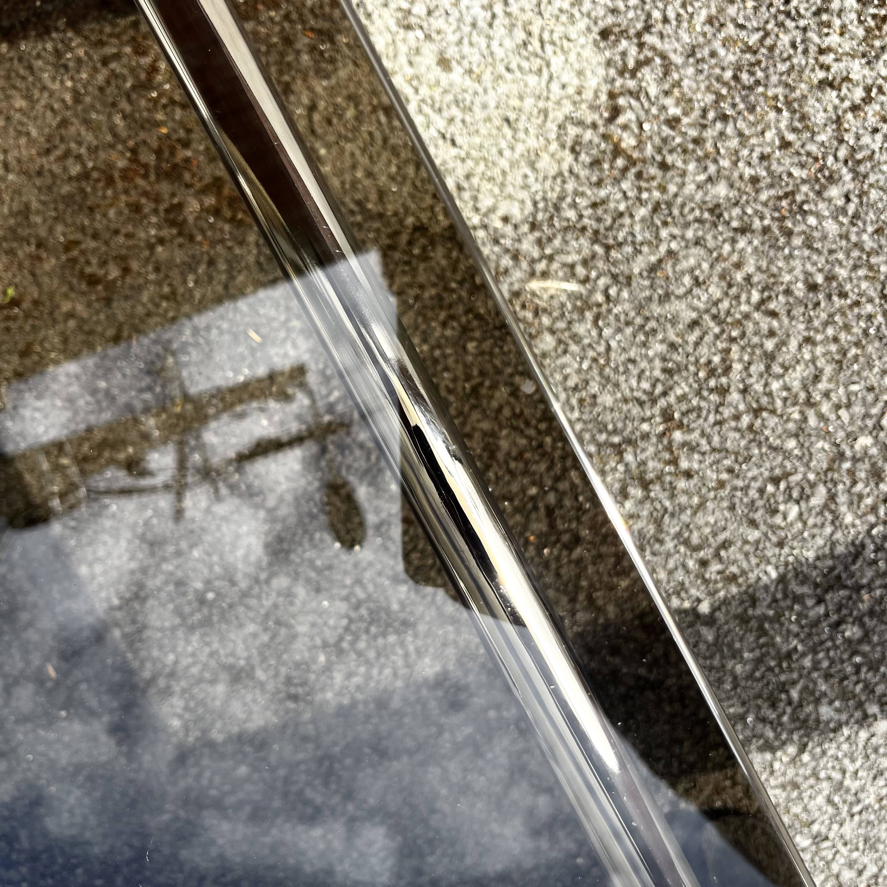 Vintage smoked glass coffee table with chrome structure.