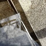 Vintage smoked glass coffee table with chrome structure.