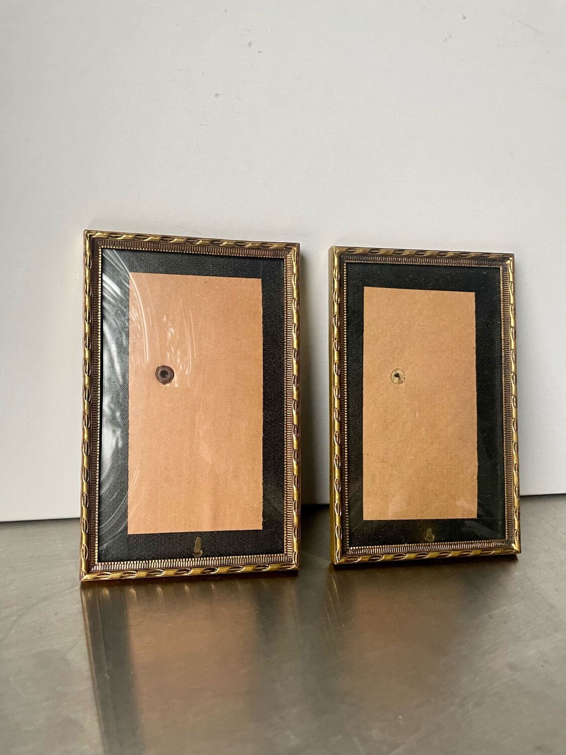 Pair of identical gold colored metal frames each measures  14.5 cm x 9 cm convex glass