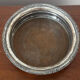 Antique silver-plated bottle coaster with floral decoration.